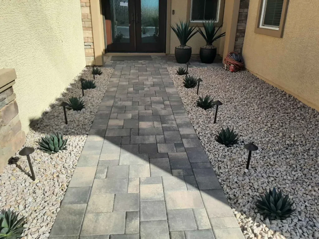 FreshStart Landscaping Vegas paver walkway with decorative rock beds and desert plants
